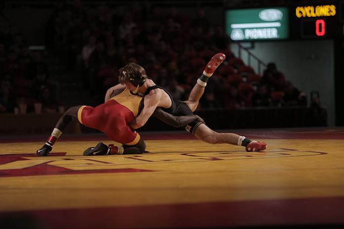Iowa 133-pounder Cory Clark takes down Iowa States Earl Hall start the Cy-Hawk series in Hilton Coliseum on Sunday, Nov. 29, 2015. Clark won by a 9-2 decision over Hall. The Hawkeyes defeated the Cyclones, 33-6. (The Daily Iowan/Margaret Kispert)