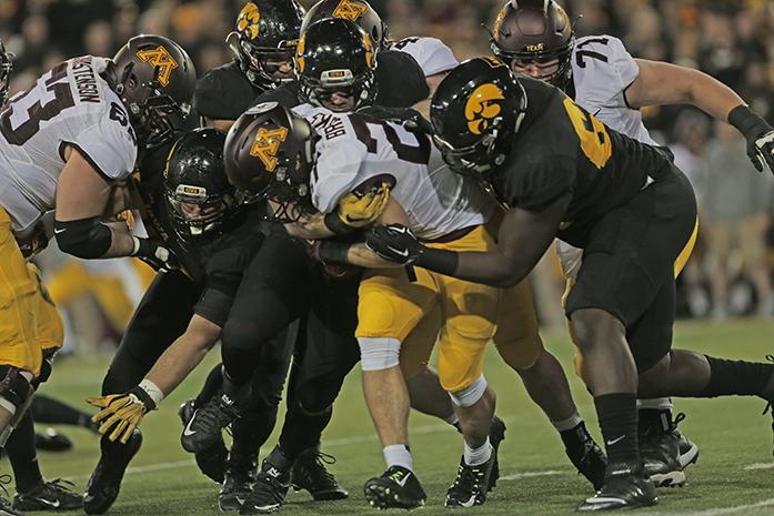 Minnesota running back Shannon Brooks gets tackled by a cluster of Iowa defensive players during the Iowa-Minnesota game at Kinnick on Saturday, Nov. 14, 2013. The Hawkeyes defeated the Golden Gophers, 40-35 to stay perfect on the season. (The Daily Iowan/Margaret Kispert)