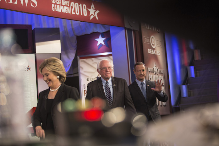 From left: Presidential candidates Hillary Clinton, Bernie Sanders, and Martin O’Malley exit the stage at Sheslow Auditorium at Drake University in Des Moines. The three candidates are at the university for the second Democratic presidential candidate of the presidential nomination election cycle. (The Daily Iowan/Brooklynn Kaschel)
