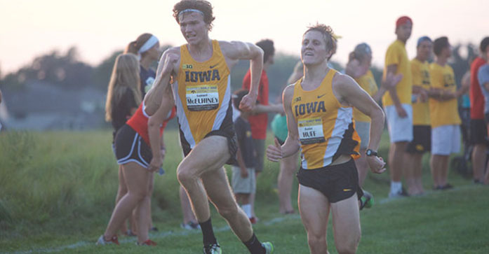 Junior Sam McElhiney and Senior Daniel Huff battle towards the finish line during the mens 6k race on Friday, Sep. 4, 2015 at the Ashton Cross Country Course in Iowa City, Iowa. (The Daily Iowan/Brooklynn Kascel)