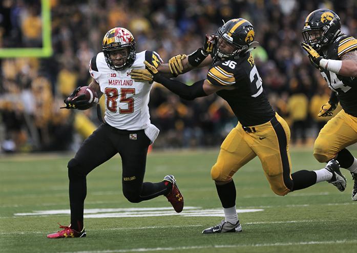 Maryland wide receiver Jarvis Davenport tries to avoid a tackle by Iowa line back Cole Fisher during the Iowa-Maryland game at Kinnick Stadium on Saturday, Oct. 31, 2015. The Hawkeyes defeated the Terrapins to stay undefeated, 31-15. (The Daily Iowan/Margaret Kispert)