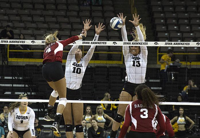 Wisconsin Outside Hitter Kelli Bates sends the ball back to Iowa as Iowa’s Setter Loxley Keala and Middle Blocker Mikaela Gunderson jump to defend, the Hawkeyes were defeated by the Badgers 3-0 on Friday, Oct. 23, at Carver-Hawkeye Arena in Iowa City.(The Daily Iowan/Anthony Vazquez)
