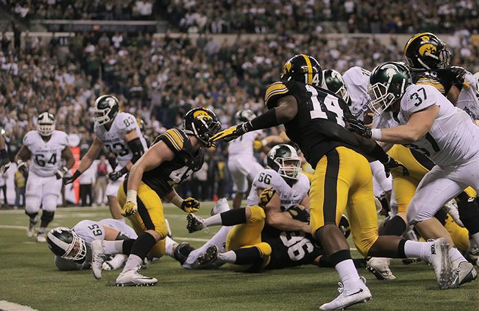 Michigan State quarterback Connor Cook attempts to score a touchdown but is stopped at the 1-yard line for a first down during the Big Ten Championship against Iowa in Lucas Oil Stadium in Indianapolis on Saturday, Dec. 5, 2015. The Spartans defeated the Hawkeyes in the last seconds of the game, 16-13. (The Daily Iowan/Margaret Kispert)