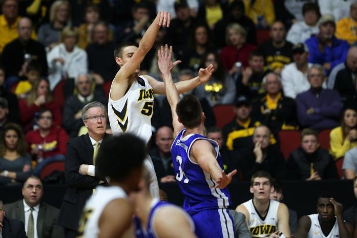Iowa's Nicholas Baer shoots over a Drake player. The Hawkeyes beat the Bulldogs 70-64 in the Big Four Classic (Joshua Housing/The Daily Iowan)