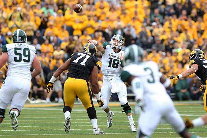 Michigan State quarterback Connor Cook throws a pass in Kinnick Stadium on Saturday, Oct. 5, 2013. Cook threw for 277 yards and two touchdown passes on the game. The Spartans defeated the Hawkeyes, 26-14. (The Daily Iowan/Tessa Hursh)