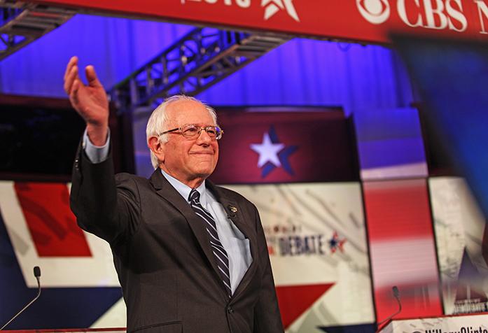 Democratic presidential candidate Bernie Sanders waves to the crowd during the photo spray before the start of the Democratic debate on Saturday, Nov. 14. The debate took place in Carnegie Hall on Drake University's campus. (The Daily Iowan/Brooklynn Kascel)