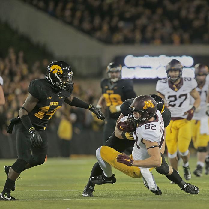 Minnesota wide receiver Drew Wolitarsky is tackled by Iowa lineman Josey Jewell during the Iowa-Minnesota game at Kinnick on Saturday, Nov. 14, 2013. The Hawkeyes defeated the Golden Gophers, 40-35 to stay perfect on the season. (The Daily Iowan/Margaret Kispert)