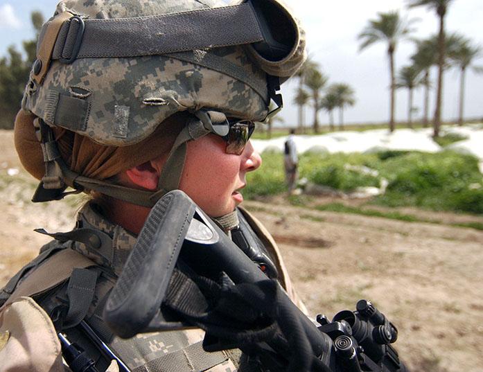 U.S. Army Sgt. Ashley Hort keeps her weapon at the ready as she provides security for her fellow soldiers during a raid in Al Haswah, Iraq, on March 21, 2007.  Hort is a team sergeant with the 127th Military Police Company deployed from Hanau, Germany. DoD photo by Spc. Olanrewaju Akinwunmi, U.S. Army.  (Released)