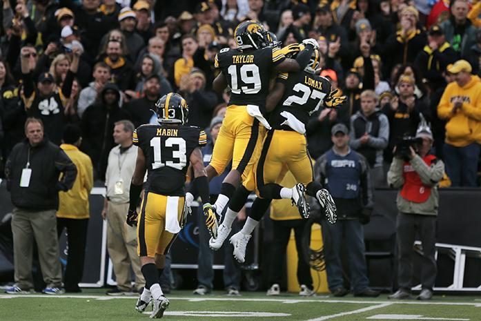 Iowa defensive backs Miles Taylor and Jordan Lomax celebrates Lomaxs interception during the Iowa-Maryland game at Kinnick Stadium on Saturday, Oct. 31, 2015. The Hawkeyes defeated the Terrapins to stay undefeated, 31-15. (The Daily Iowan/Margaret Kispert)