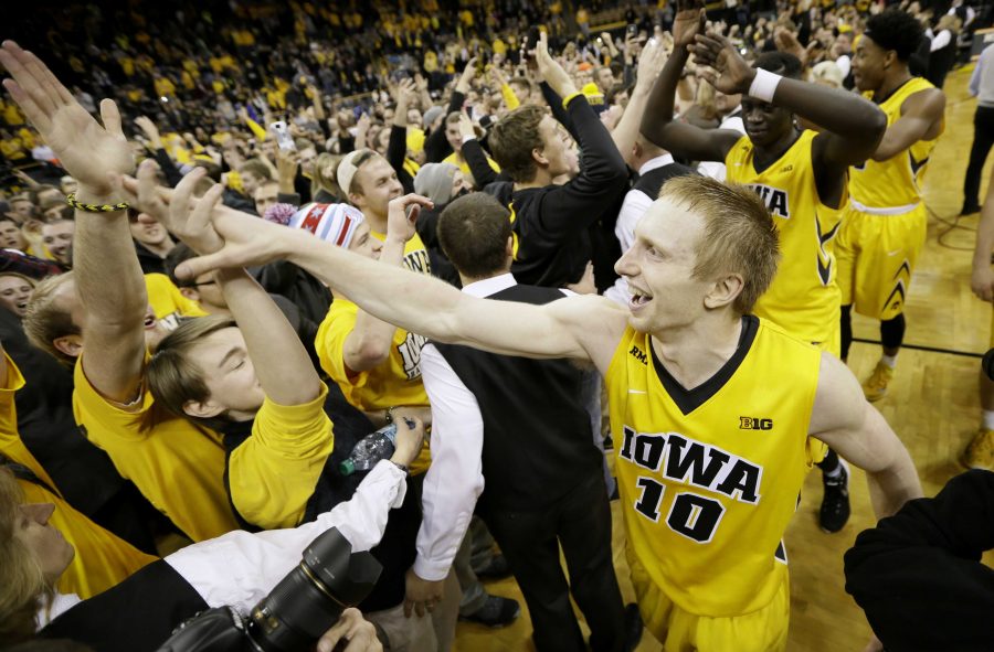Iowa guard Mike Gesell celebrates with fans after an NCAA college basketball game against Michigan State, Tuesday, Dec. 29, 2015, in Iowa City, Iowa. Gesell scored 25 points as Iowa won 83-70. (AP Photo/Charlie Neibergall)