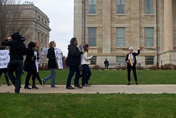 Carleen Maur leads a group of protesters to the president's office in hopes that he would answer a few questions on Thursday, Dec. 17 2015. (The Daily Iowan/Jordan Gale)