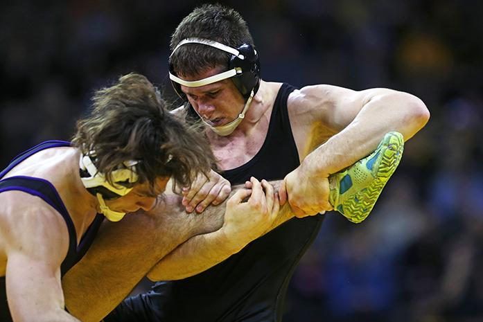 Iowa 197 lbs. Nathan Burak wrestles against Northwesterns Alex Polizzi at Carver-Hawkeye Arena on Friday, Jan. 23, 2015 in Iowa City, Iowa. Burak defeated Polizzi by decision, 4-3. The Hawkeyes defeated the Wildcats, 38-3. (The Daily Iowan/Joshua Housing)