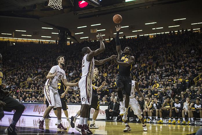 Hawkeye senior Anthony Clemons shoots over a defender during a game between the Hawkeyes and Florida State University on Wednesday, Dec. 2, 2015. The Hawkeyes beat the Seminoles 78-75 in overtime. (The Daily Iowan/Sergio Flores)