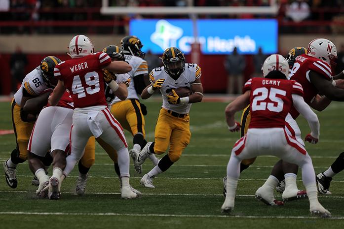 Iowa running back Jordan Canzeri finds a hole in the line during the Iowa-Nebraska game at Memorial Stadium on Friday, Nov. 27, 2015. The Hawkeyes defeated the Cornhuskers, 28-20, to finish off a perfect regular season. (The Daily Iowan/ John Theulen)