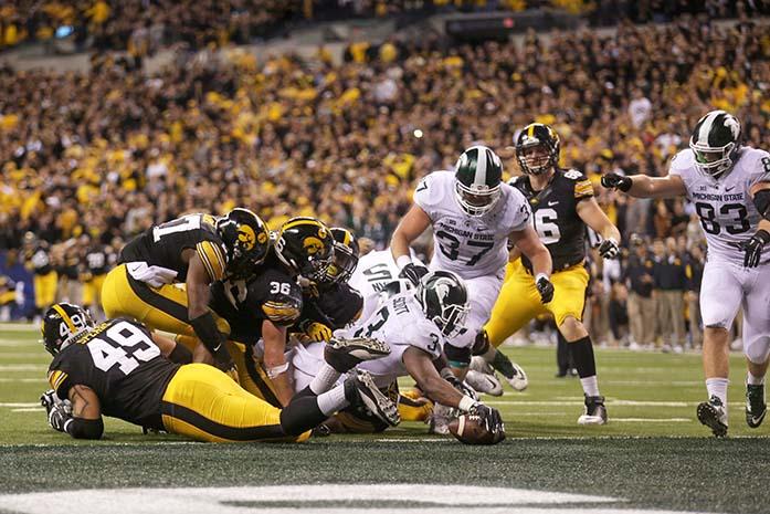 Michigan State running back LJ Scott scores a touchdown putting them in the lead with 27 seconds left in the fourth quarter during the Big Ten Championship against Michigan State in Lucas Oil Stadium in Indianapolis, Indiana on Saturday, Dec. 5, 2015. The Spartans defeated the Hawkeyes, 16-13. (The Daily Iowan/Alyssa Hitchcock)