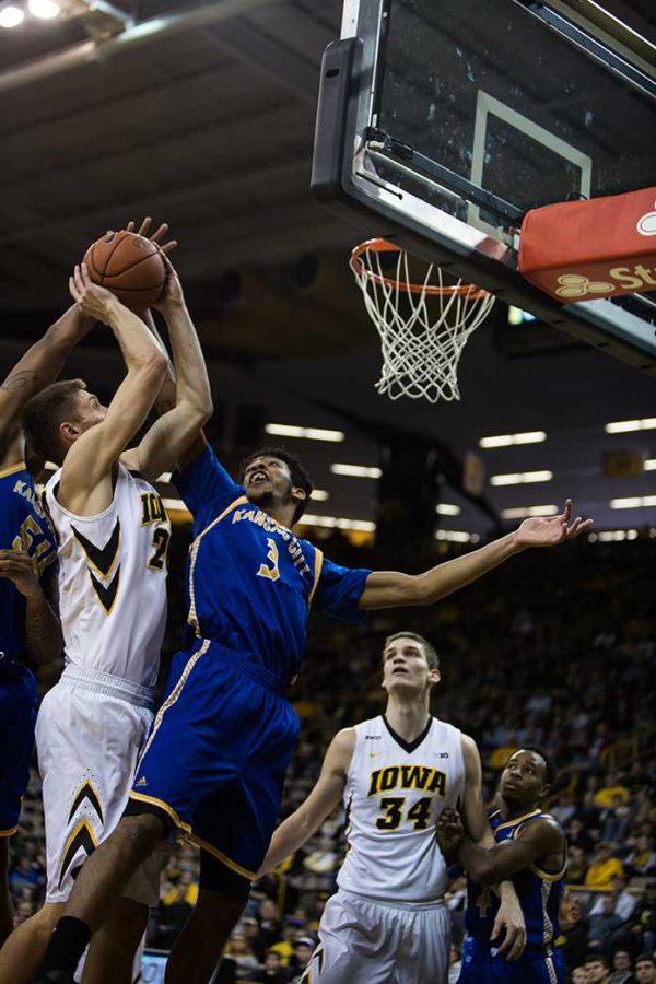 Iowa forward Jarrod Uthoff faces heavy opposition from the UMKC defense as he attempts a shot, the Hawkeyes defeated the Kangaroos 95-75  at Carver-Hawkeye Arena in Iowa City,Iowa on Dec. 5,2015(The Daily Iowan/Anthony Vazquez)