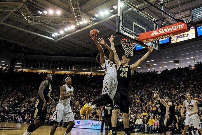 Iowa forward Dom Uhl jumps up to the basket as Purdue’s Isaac Haas tries to block him. The then-No. 9 Hawkeyes beat No. 22 Purdue, 83-71, in Carver-Hawkeye on Sunday. (The Daily Iowan/Anthony Vazquez)