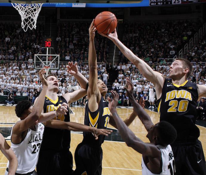 Iowas Jarrod Uthoff (20), Christian Williams, center, and Adam Woodbury, second from left, and Michigan States Deyonta Davis (23) and Eron Harris (14) reach for a rebound during the first half of an NCAA college basketball game, Thursday, Jan. 14, 2016, in East Lansing, Mich. (AP Photo/Al Goldis)
