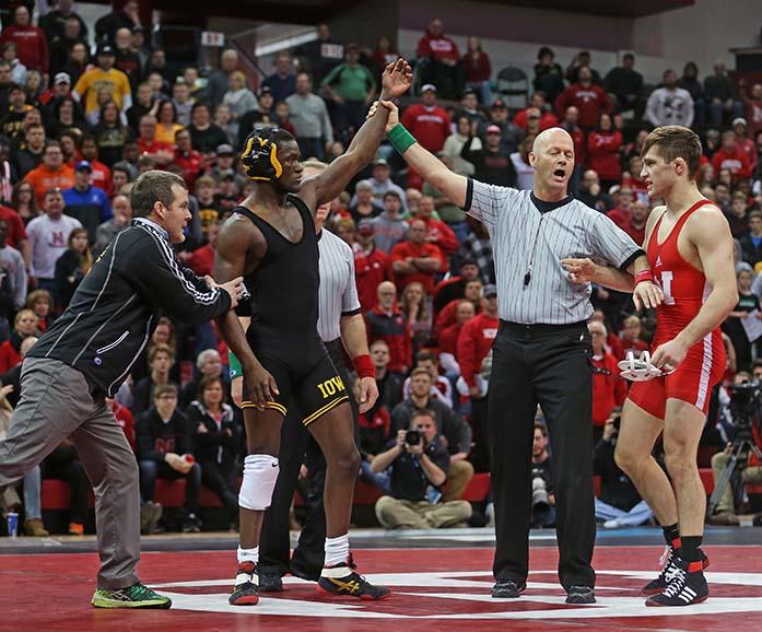 Iowa head coach pulls 157-pounder Edwin Cooper Jr. away from the middle of the circle after defeating Nebraskas Tyler Berger during the Iowa-Nebraka match in the Devaney Center in Lincoln, Nebraska on Sunday, Jan. 24, 2016. Cooper held on the win over Berger with a 7-6 decision. The Hawkeyes defeated the Cornhuskers, 21-11. (The Daily Iowan/Margaret Kispert)
