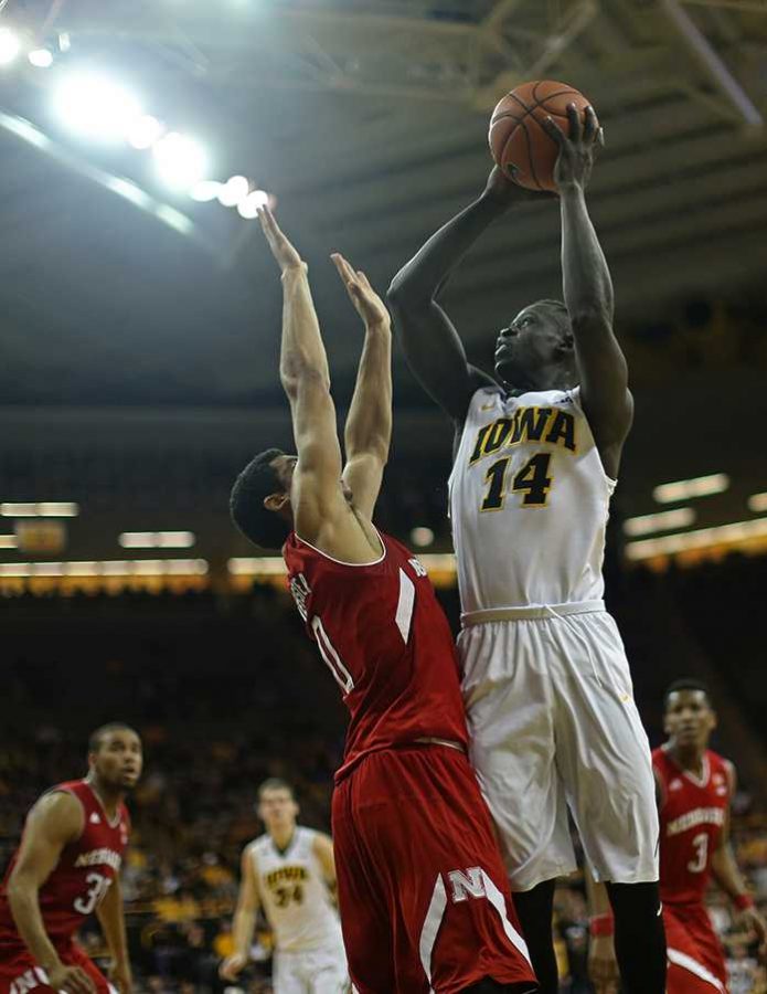 Iowa guard Peter Jok shoots the ball over Nebraska guard Tai Webster during the Iowa-Nebraska game in Carver-Hawkeye Arena on Tuesday, Jan. 5, 2016. The Hawkeyes defeated the Cornhuskers, 77-66. (The Daily Iowan/Margaret Kispert)