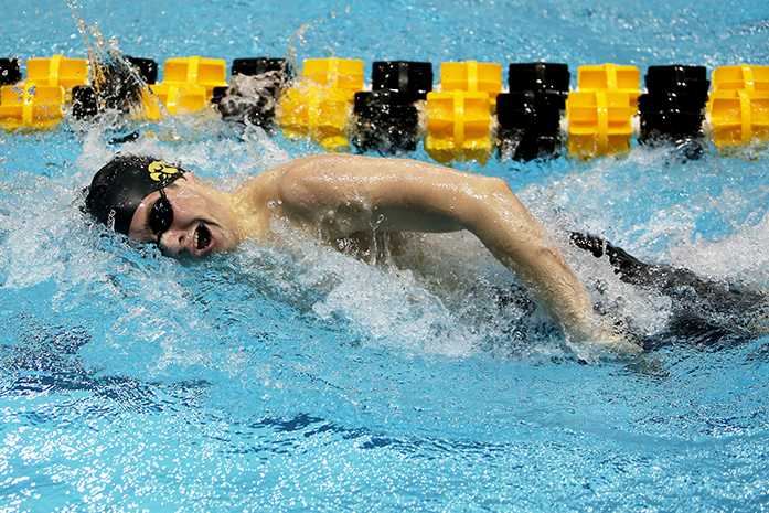 A member of the Iowa 800 freestyle relay races down the pool during the first day of the Big 10 Mens Swimming and Diving Championships at the Campus Recreation and Wellness Center on Wednesday, Feb. 25, 2015. Iowa finished seventh in the race with a time of 6:29.57.