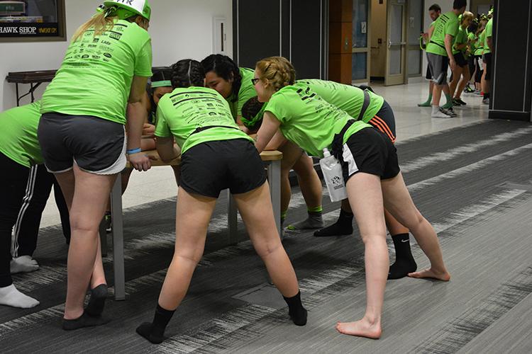 Dancers try to rest without sitting down during the 6th hour of the 22nd Dance Marathon in the Iowa Memorial Union on Satruday, Feb. 6, 2016. The dancers are not allowed to sit, or have caffeine throughout the 24 hours. (The Daily Iowan/Valerie Burke)