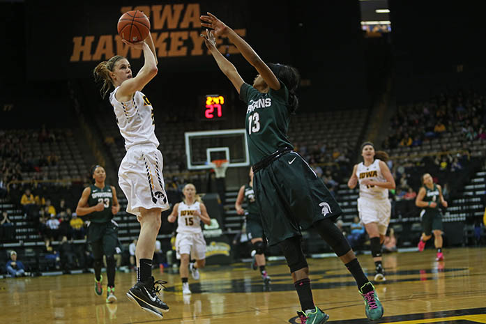 Iowa forward, Christina Buttenham, takes the shot over Michigan State guard, Morgan Green, during the Iowa-Michigan State game in Carver-Hawkeye Arena on Sunday, Feb. 7, 2016. The Spartans defeated the Hawkeyes, 74-69. (The Daily Iowa/ Margaret Kispert)