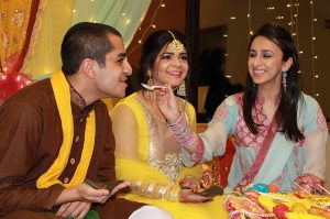 Sharukh Hasan and Ariana Dewan are fed in Mehndi Nights pre-wedding ceremony in the Old Capitol Mall on Friday, Feb. 12, 2016. The Pakistani Student Alliance and the South Asian Student Alliance sponsored the event. 