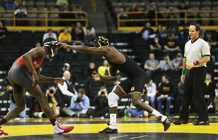 Iowas Edwin Cooper Jr. moves toward North Carolina States Tommy Gantt at 157 pounds during the NWCA National Duels Championship Series on Monday, Feb. 22. 2016 in Carver-Hawkeye.  Gantt defeated Cooper Jr., 13-5 in a major decision. (The Daily Iowan/Brooklynn Kascel)