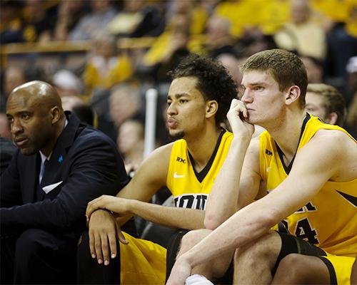 Iowa center Adam Woodbury and forward Dom Uhl watch during the Iowa-Wisconsin game in Carver-Hawkeye on Wednesday. The Hawkeyes fell to the Badgers, 67-59. (The Daily Iowan/Anthony Vazquez)