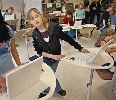 Stephanie Mueller works at a standing desk in an experimental classroom at Elton Hills Elementary School in Rochester, Minn. Mayo Clinic obesity researchers want to learn whether classrooms really need desks, or if being able to move around helps students fight obesity and learn at the same time. (Associated Press/Janet Hostetter)