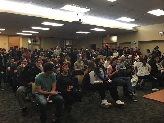 Caucus-goers sit in the Iowa City Public Library, a Democratic site.