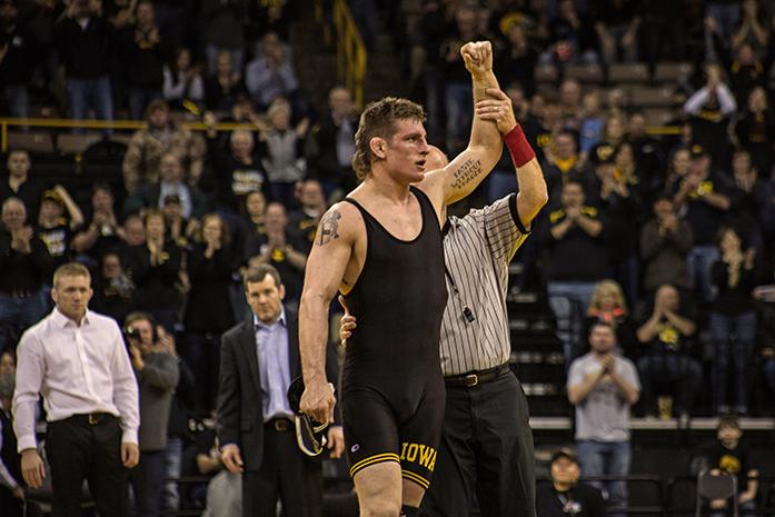 Iowas Sammy Brooks has his hand held up in victory after a tech. fall against Minnesotas Chris Pfarr in 3:00 on Friday, Jan. 29, 2016. The #2 Iowa Hawkeyes defeated the #23 Minnesota Gophers 34-6 at Carver-Hawkeye. (The Daily Iowan/Anthony Vazquez)