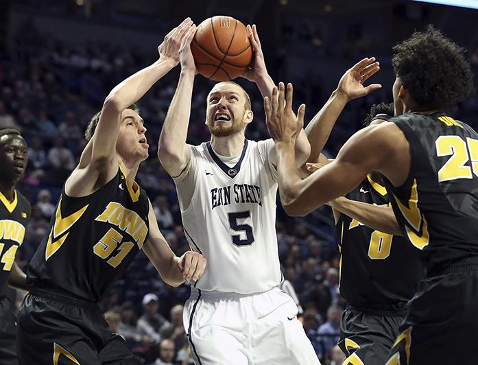 Penn State forward Donovan Jack (5) drives to the basket as Iowa forward Nicholas Baer (51) defends during the first half of an NCAA college basketball game, Wednesday, Feb. 17, 2016, in State College, Pa. (AP Photo/Chris Knight)