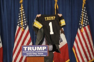 Iowa tight end Peter Pekar holds up a jersey with Trump printed on the back during Donald Trump’s speech at the Field House on Jan. 26. (The Daily Iowan/Jordan Gale)