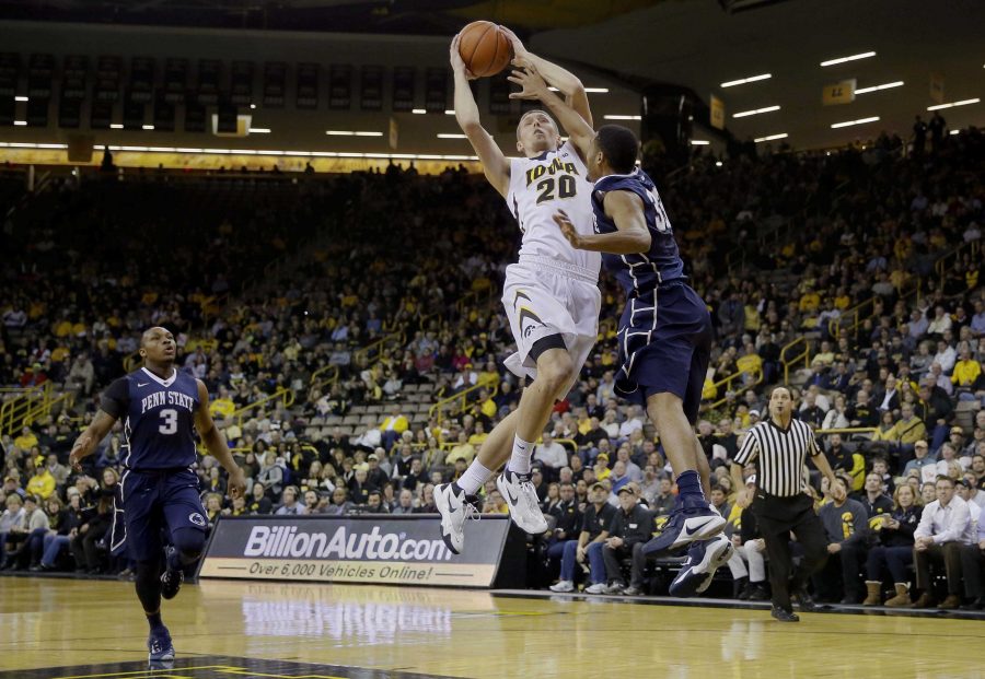 Iowa forward Jarrod Uthoff (20) drives to the basket over Penn State guard Shep Garner, right, during the first half of an NCAA college basketball game, Wednesday, Feb. 3, 2016, in Iowa City, Iowa. Uthoff scored 14 points as Iowa won 73-49. (AP Photo/Charlie Neibergall)