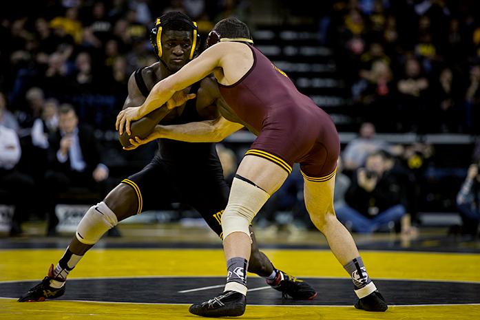 Iowas Edwin Cooper, Jr grapples with Minnesotas Brandon Kingsley, the #2  Iowa Hawkeyes defeated the #23 Minnesota Gophers 34-6  at Carver-Hawkeye Arena in Iowa City, Iowa on Friday Jan. 29, 2016(The Daily Iowan/Anthony Vazquez)