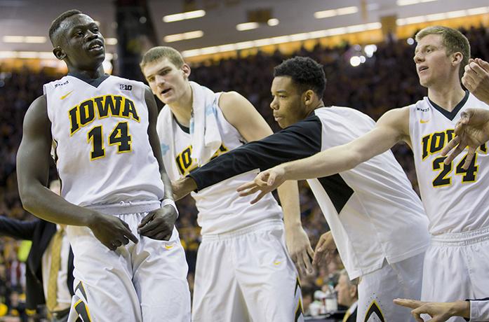 Iowa guard Peter Jok is cheered by the bench after hitting a three pointer during the second half of an NCAA college basketball game against Northwestern, Sunday, January 31, 2016, in Iowa City, Iowa. Iowa won 85-71. (AP Photo/Justin Hayworth)