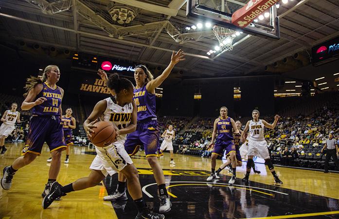 Iowa forward Tania Davis looks for an open team member for a pass. Iowa defeated Western Illinois in overtime 96-81 in Carver-Hawkeye Arena on Nov. 19 in Iowa City, Iowa.(The Daily Iowan/Anthony Vazquez)