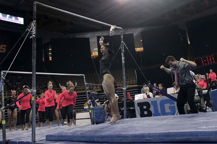 Iowa+gymnast+Johanny+Sotillo+celebrates+her+stick+landing+on+the+bars+during+the+Iowa-Illinois+meet+in+Carver-Hawkeye+Arena+on+Saturday%2C+Feb.+14%2C+2015.+Sotillo+received+9.825+and+placed+seventh+on+the+bars.+The+Fighting+Illini+defeated+the+Hawkeyes+with+an+overall+score+of+196.975+to+196.375.+%28The+Daily+Iowan%2FMargaret+Kispert%29