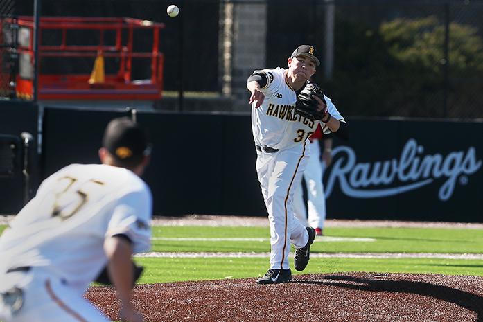 Iowa pitcher Nick Gallagher attempts to throw out the runner at first during the Iowa-Grand View game at Duane Banks Field on Tuesday, March 31, 2015. The Hawkeyes defeated the Vikings 9-2. (The Daily Iowan/John Theulen)