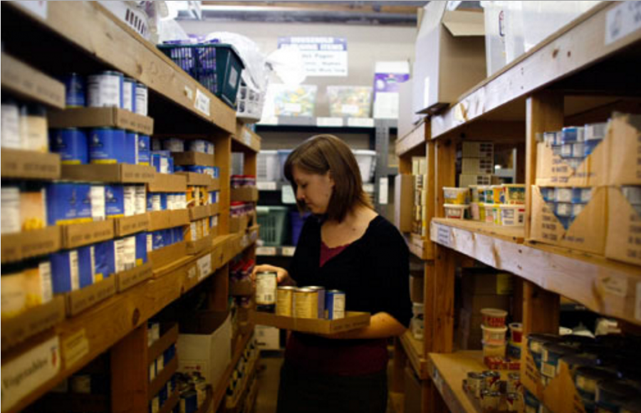 Alex Crider/The Daily Iowan
Sarah Witry organizes food in the Crisis Center Food Bank on Tuesday. Witry says every person who is affected by the Crisis Center makes her job worthwhile.