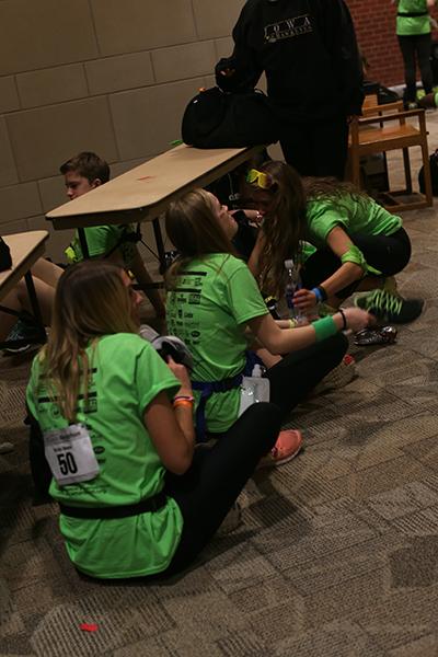 Dancers sit on the floor during the 8th hour of the 22nd Dance Marathon in the Iowa Memorial Union on Saturday, Feb. 6, 2016. Members are not allowed to sit or sleep for the full 24 hours. (The Daily Iowan/Margaret Kispert)