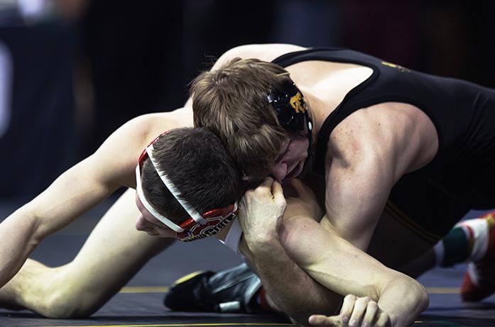 Iowas 133-pounder Cory Clark isolates the arm of Ohio States Johnni DiJulius during the first round of the Big Ten Championships at Carver-Hawkeye Arena on Saturday, March 5, 2016. Iowas Clark defeated Dijulius in a decision 7-3. (The Daily Iowan/Anthony Vazquez)