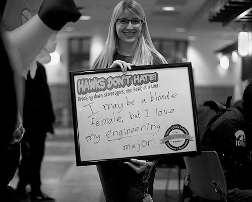 Hannah Dobroski a freshman at the University of Iowa holds up her sign for Hawks Don't Hate at Burge Hall on Tuesday, March 1, 2016. The Herky Cares Project is a student organization that is sponsored by Residence Education in University Housing & Dining at the University of Iowa. (The Daily Iowan/Jordan Gale)