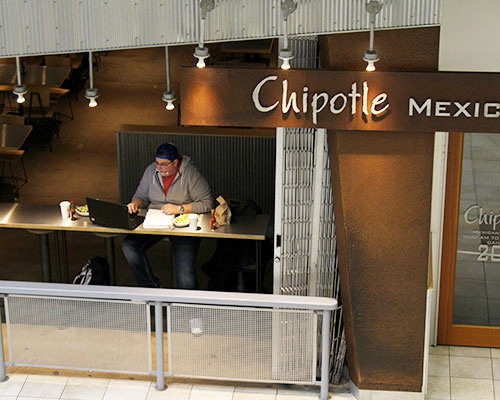 Senior Austin Akers finds a spot in Chipotle for a quick meal and study session on Wednesday, March 2. Chipotle is located in the Old Capitol Mall and is open everyday from 11am-10pm. (The Daily Iowan/ Alex Kroeze)