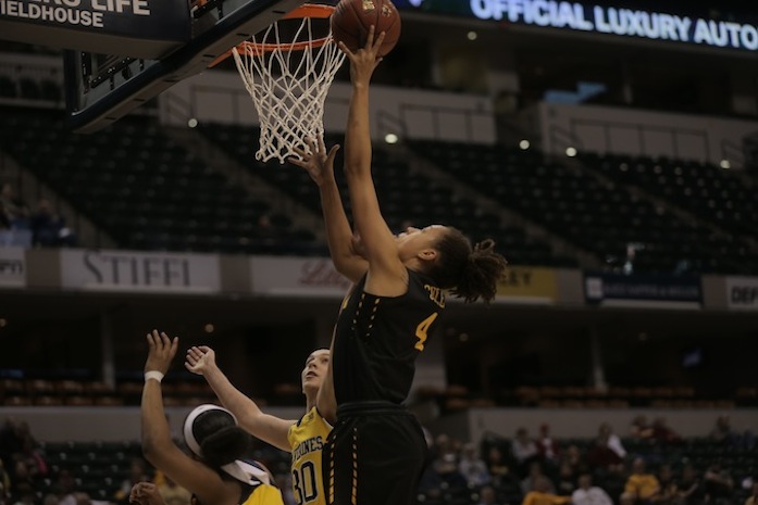 Iowa forward Chase Coley goes up for a basket over Michigan center Hallie Thome during Game 3 of the Womens Big Ten tournament in Bankers Life Fieldhouse in Indianapolis on Thursday, March 3, 2016. The Hawkeyes defeated the Wolverines, 97-85. Iowa will play No. 1 ranked Maryland tomorrow, March 4 at 1 p.m. Central Time. (The Daily Iowan/Margaret Kispert)