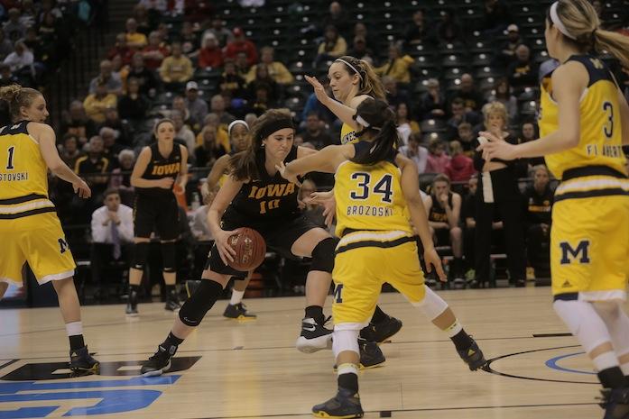 Iowa forward Megan Gustafson tries to drives down the lane full of Michigan defenders during Game 3 of the Womens Big Ten tournament in Bankers Life Fieldhouse in Indianapolis on Thursday, March 3, 2016. The Hawkeyes defeated the Wolverines, 97-85. Iowa will play top-ranked Maryland Friday, March 4 at 1 p.m. Central Time. (The Daily Iowan/Margaret Kispert)