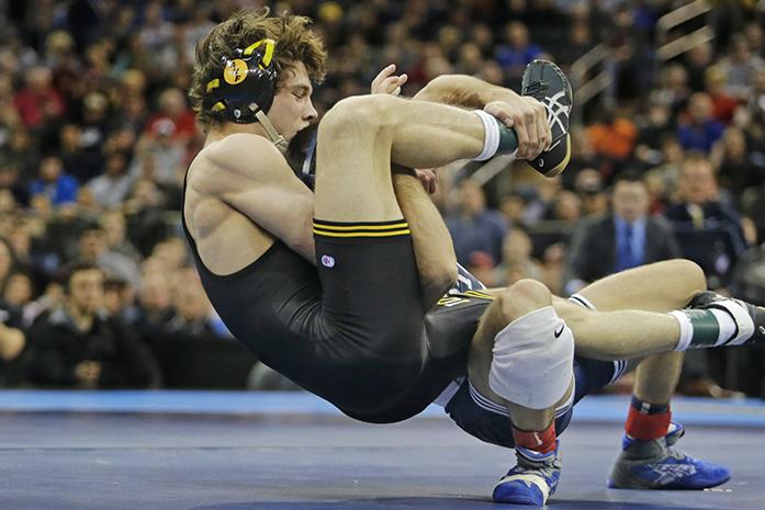 Iowa 125-pounder Thomas Gilman grabs Penn States Nico Megaludis during the NCAA Championship finals at Madison Square Garden in New York City on Saturday, March 19, 2016. Megaludis defeated Gilman, 6-3. (The Daily Iowan/Valerie Burke)