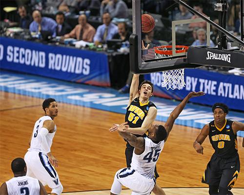 Iowa Hawkeyes forward Nicholas Baer (51) lays the ball up against Villanova Wildcats forward Darryl Reynolds (45) in the Barclays Center on Sunday, March 20, 2016 in Brooklyn, New York. Baer finished the game with 4 rebounds, 15 points, and 2 steals. The Wildcats defeated the Hawkeyes, 87-68. (The Daily Iowan/Joshua Housing)